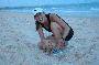 tina playing with the local puppy on the beach in mui ne
